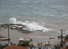 A wave splashes over Kamini Harbor in winter
